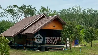 Charming rustic cabin with wooden deck nestled in lush greenery, perfect for serene countryside living.