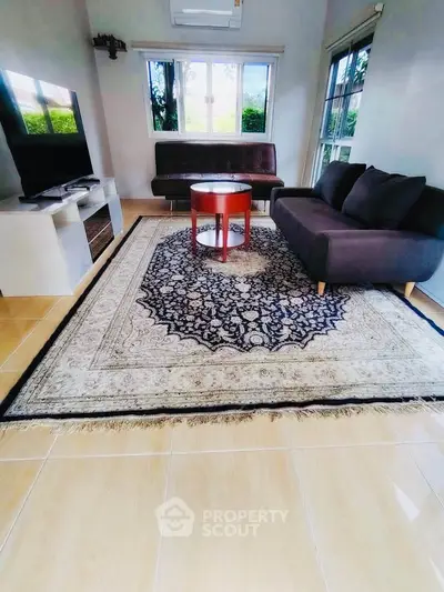 Charming living room with elegant rug and modern furniture, perfect for cozy gatherings.