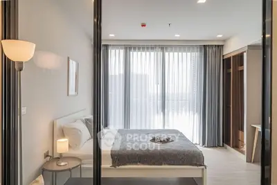 Modern bedroom with large window and stylish decor