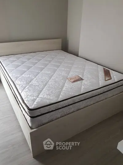Modern bedroom with stylish bed and new mattress in a cozy setting.