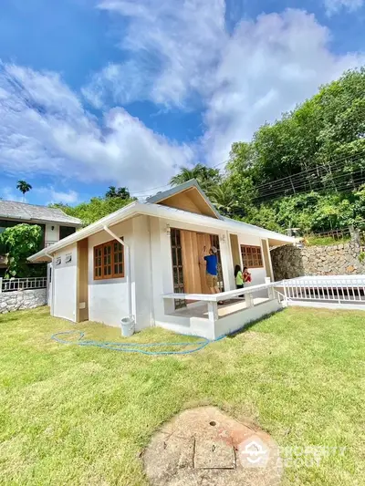 Charming small house with lush garden and scenic view, perfect for cozy living.