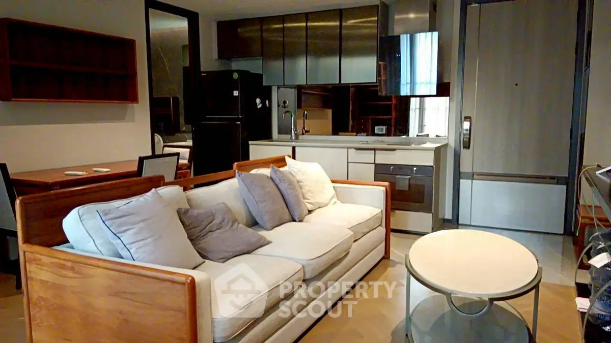 Modern living room with stylish furniture and open kitchen layout