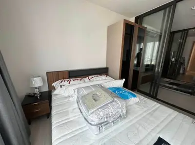 Modern bedroom with sleek design and ample natural light, featuring a comfortable bed and stylish decor.