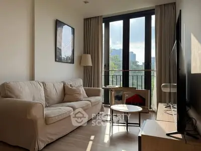 Bright living room with cozy sofa and large window offering city view