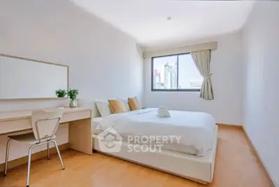 Bright and airy bedroom with city view, featuring a cozy bed and modern desk setup.
