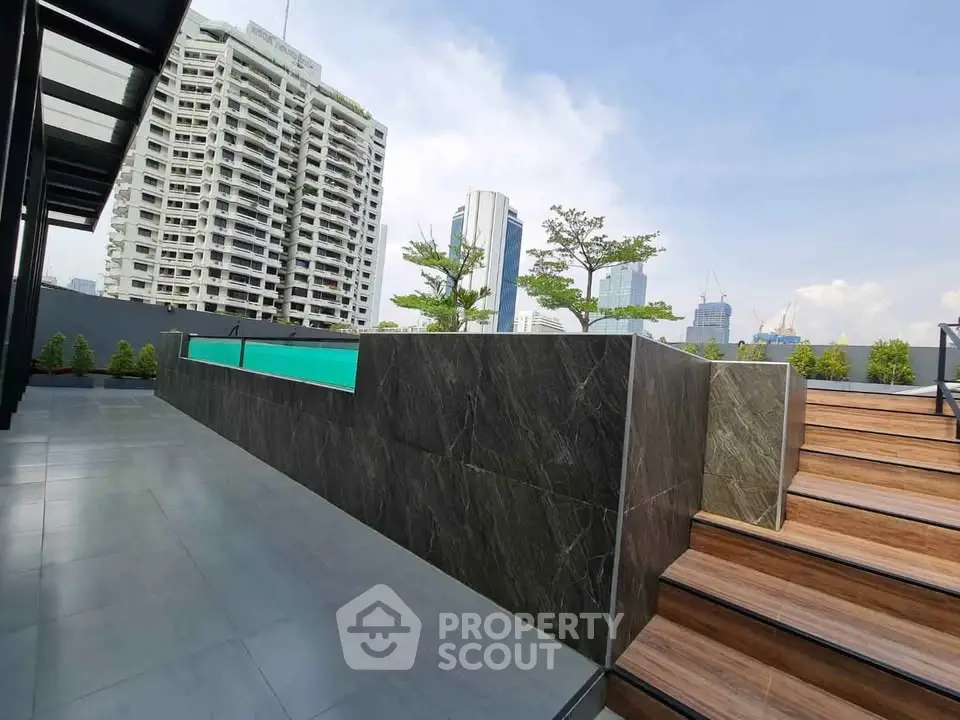Modern rooftop pool with city skyline view, perfect for urban living.