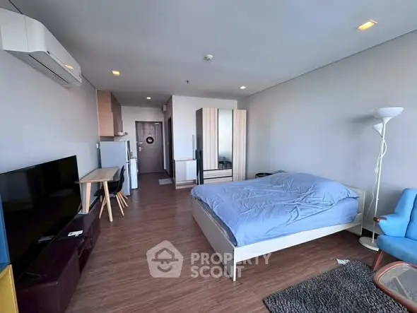 Modern studio apartment with cozy furnishings and wooden flooring