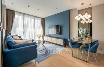 Luxurious modern living room with blue accents and elegant dining area