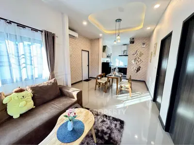 Stylish open-plan living room with cozy seating and modern dining area