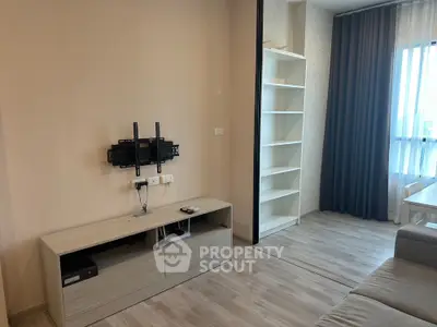Modern living room with TV mount and shelving, featuring large window and neutral decor.