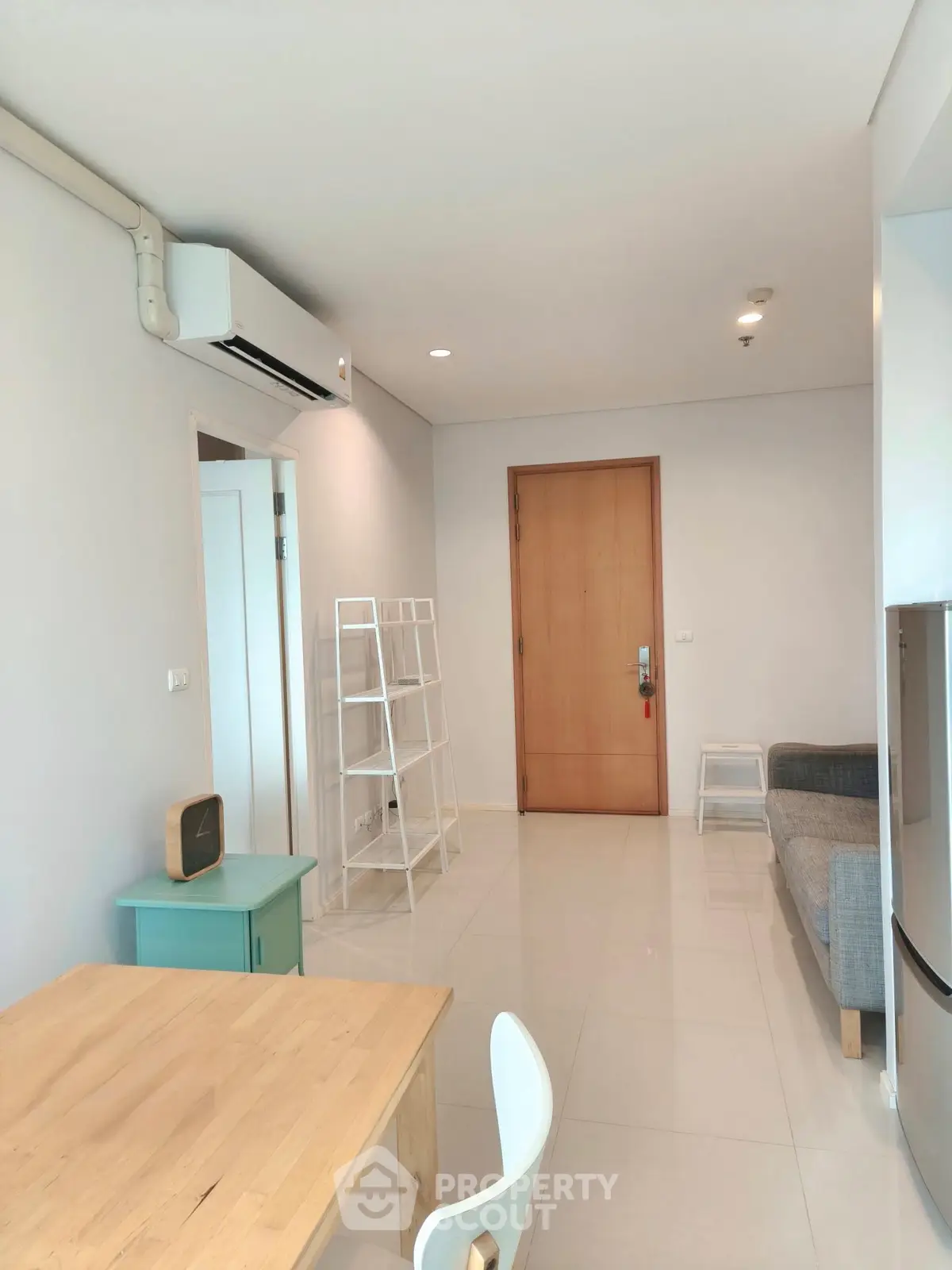 Modern living room with minimalist decor and air conditioning in a cozy apartment.