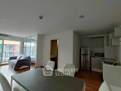 Modern apartment with open layout, featuring a cozy living area and sleek kitchen.