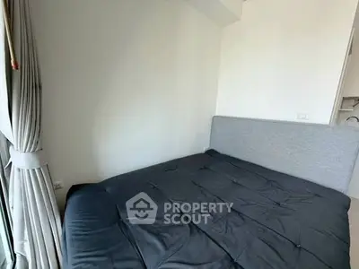 Modern bedroom with large window and stylish gray bedding