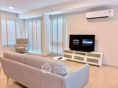 Modern living room with sleek furniture and AirPlay TV setup, perfect for relaxation and entertainment.
