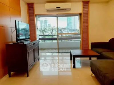 Spacious living room with modern furniture and balcony view in urban apartment.