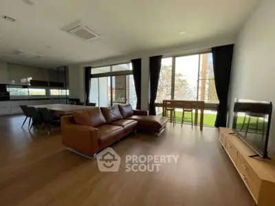 Spacious modern living room with large windows and stylish furniture
