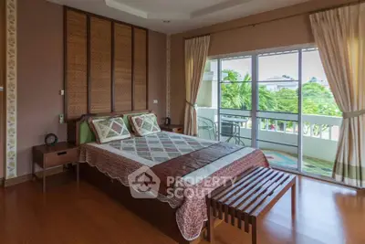 Spacious bedroom with elegant decor and balcony view