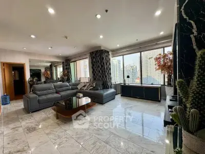 Spacious modern living room with city view, marble flooring, and stylish decor.