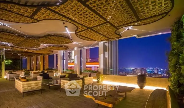 Luxurious rooftop lounge with stunning city view and elegant decor at night.