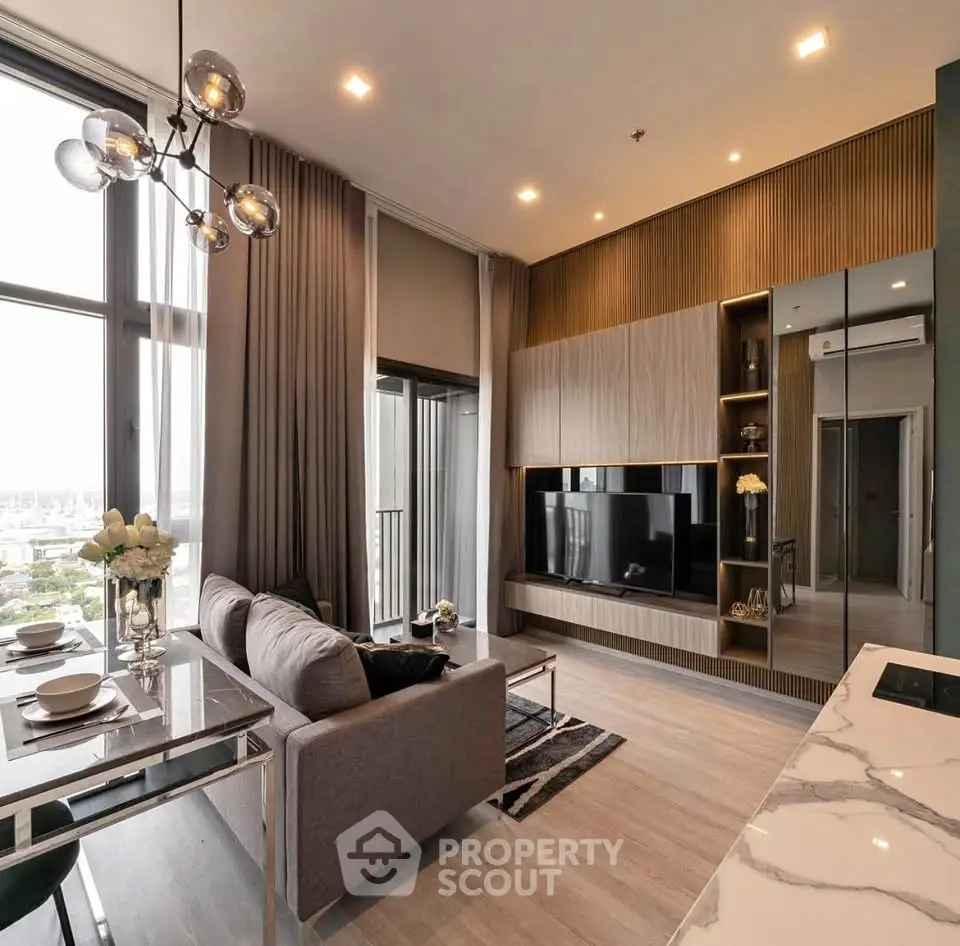 Luxurious modern living room with high ceilings and elegant decor in a high-rise apartment.
