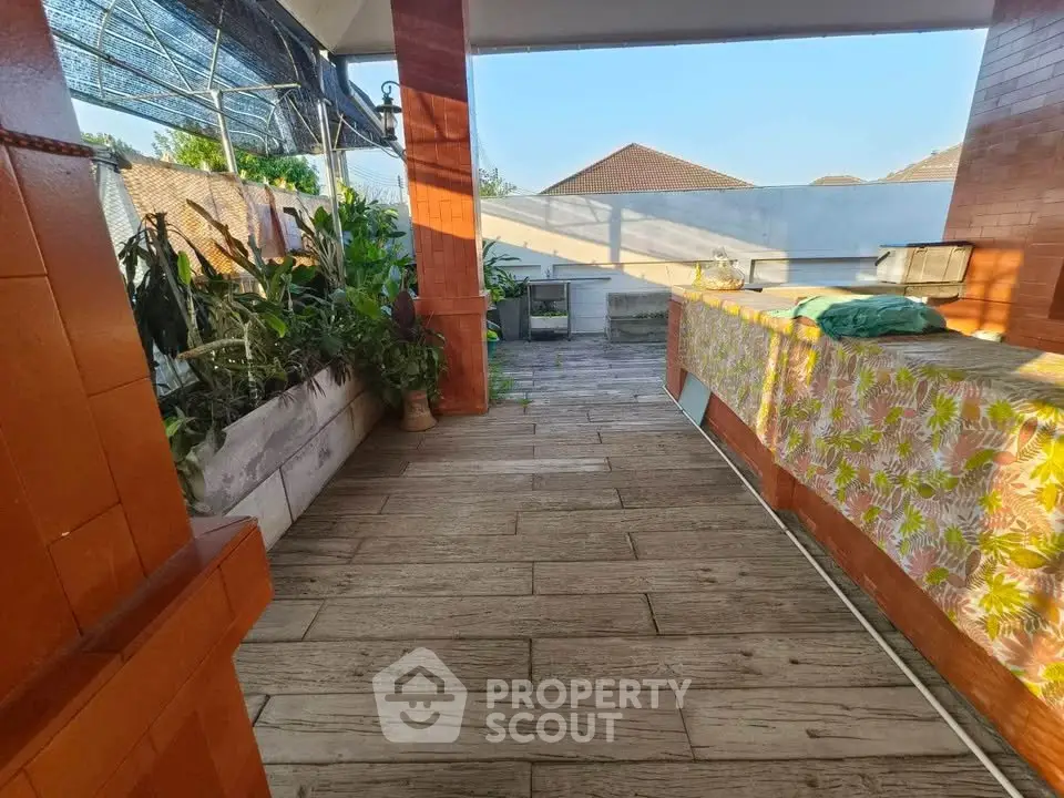 Spacious rooftop terrace with plants and seating area, perfect for relaxation.