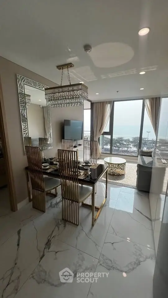 Luxurious dining area with ocean view, elegant decor, and modern furnishings in a high-end apartment.