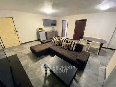 Spacious living room with modern furniture and open layout in a stylish apartment.