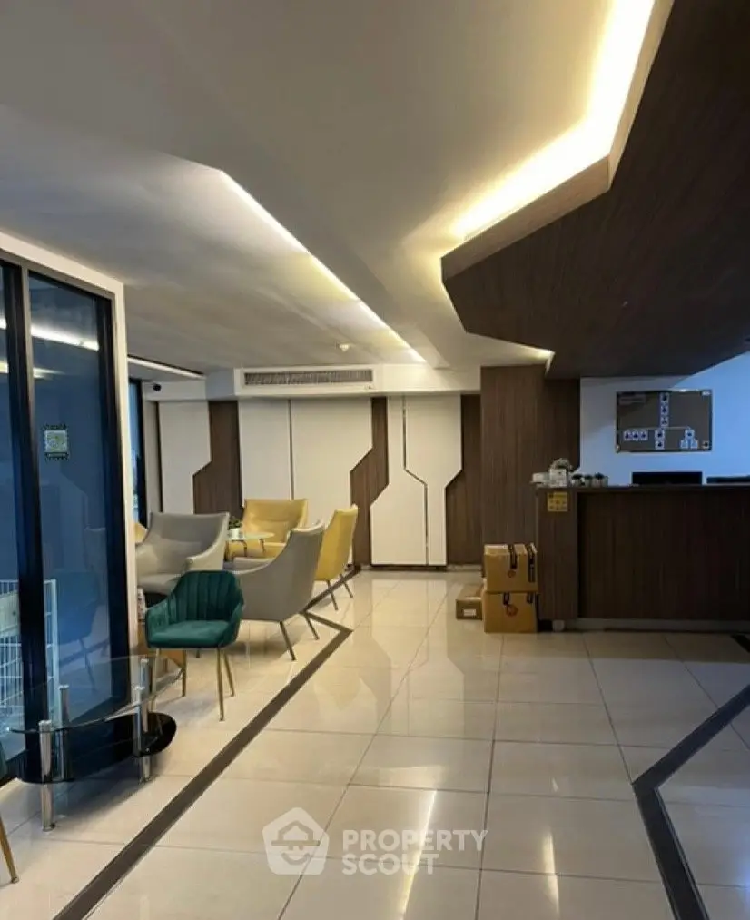 Modern lobby with stylish seating and sleek design elements in a contemporary building.