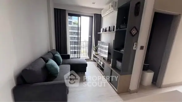 Modern living room with sleek furniture and balcony view in urban apartment