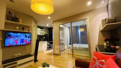 Modern open-plan living room with cozy decor and sliding glass doors to bedroom