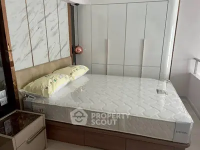 Modern bedroom with stylish bed and sleek wardrobe design.