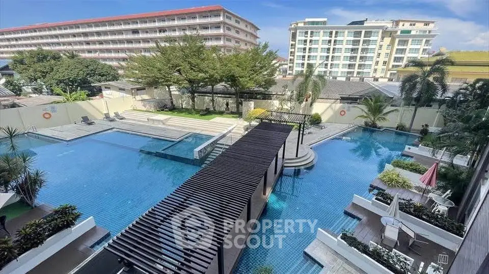 Luxurious residential complex with stunning pool and modern architecture.