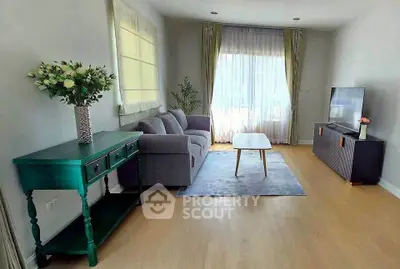 Charming living room with cozy sofa, elegant decor, and natural light perfect for relaxation.