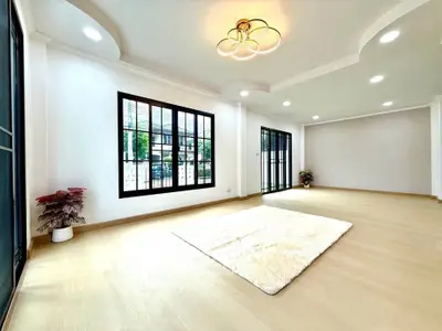 Spacious and bright living room with modern lighting and large windows