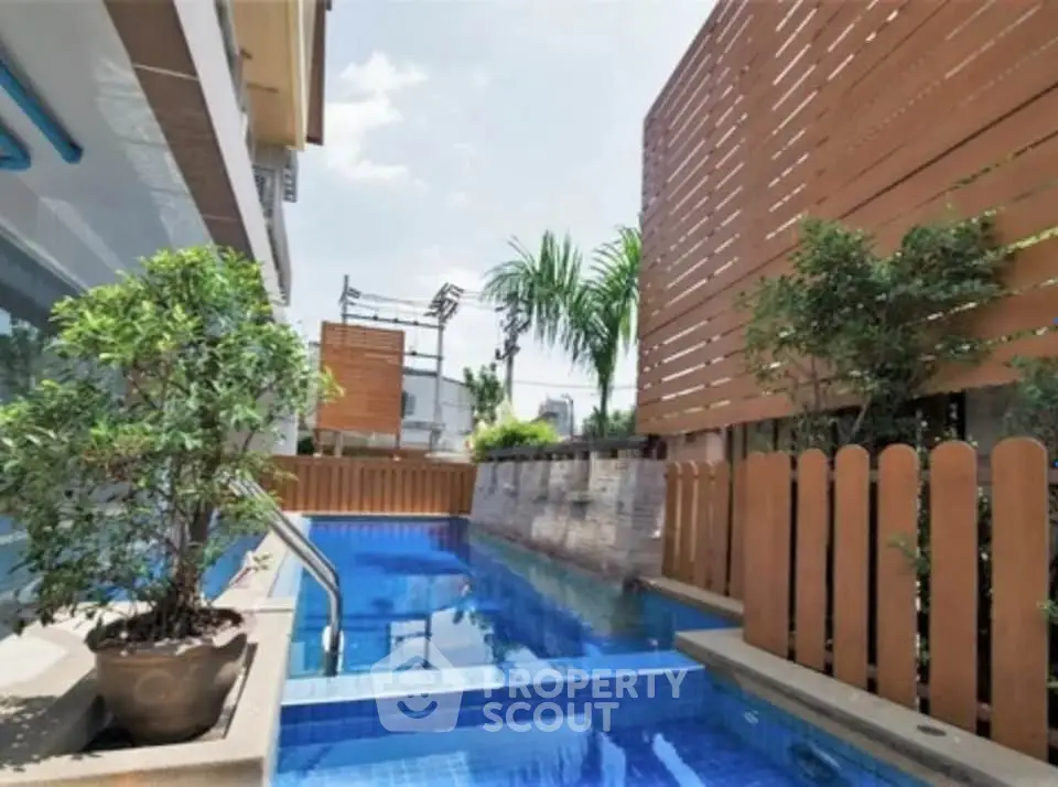 Luxurious outdoor pool area with modern design and lush greenery