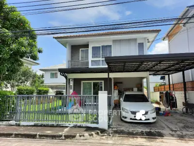 Charming two-story house with carport and lush garden in suburban neighborhood.