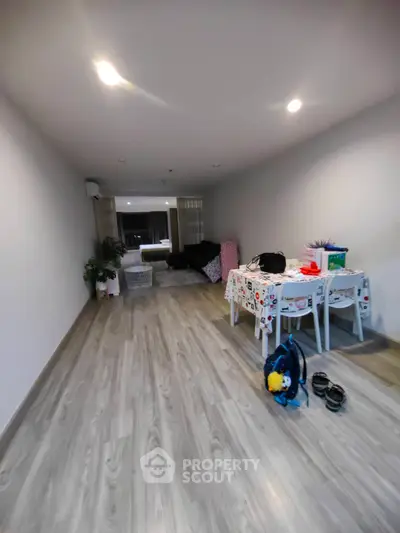 Spacious living room with modern decor and wooden flooring