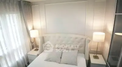 Elegant bedroom with plush headboard and soft lighting, perfect for relaxation.