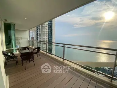 Spacious balcony with stunning ocean view in modern high-rise apartment