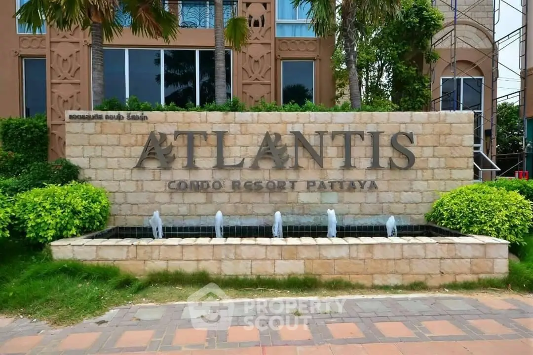 Atlantis Condo Resort Pattaya entrance with elegant stone sign and lush greenery.