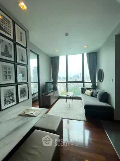 Modern living room with city view, featuring stylish decor and large windows for natural light.