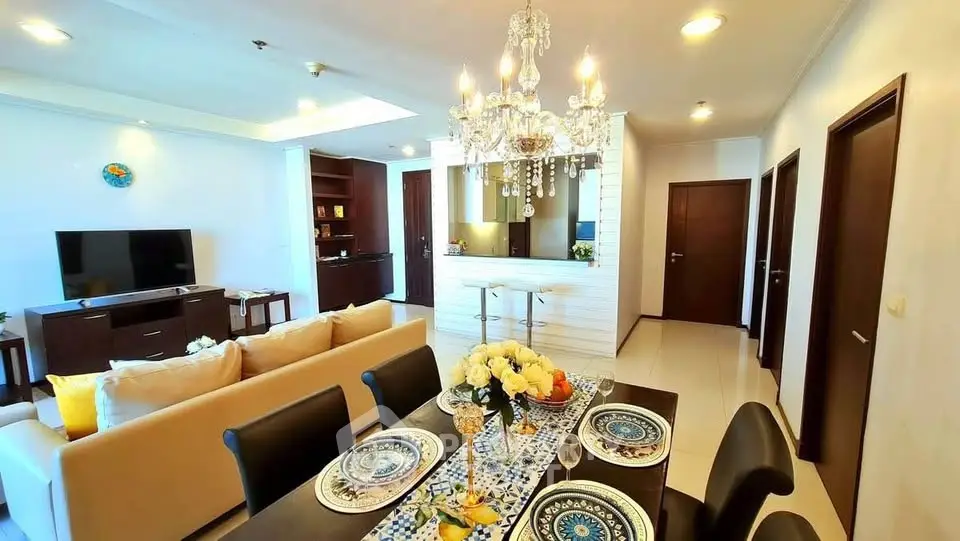 Luxurious open-plan living and dining area with elegant chandelier and modern decor