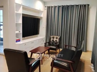 Stylish living room with modern furniture and large TV unit, perfect for relaxation and entertainment.