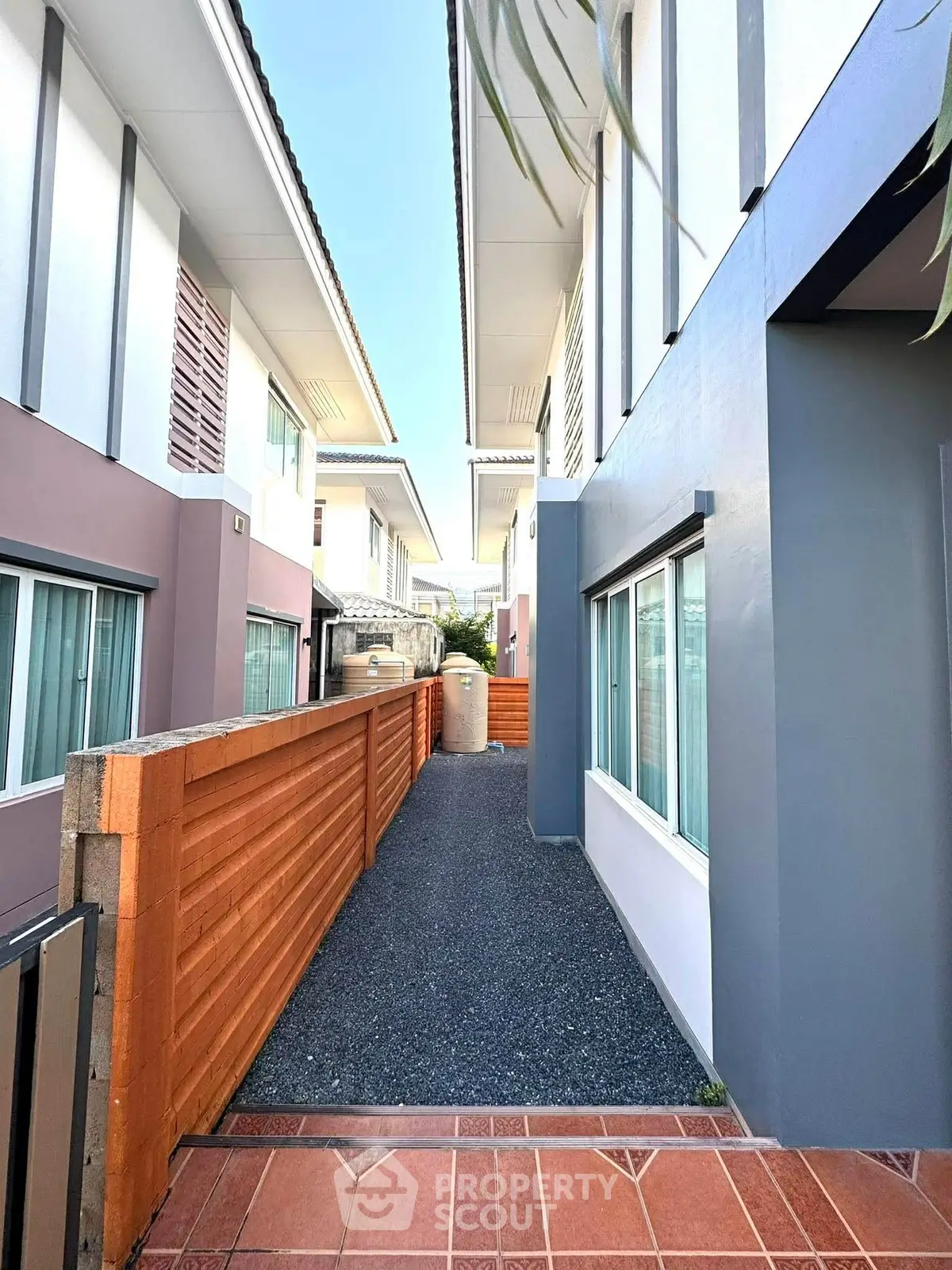 Modern townhouse exterior with sleek design and private walkway