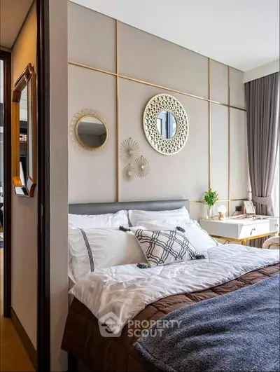 Elegant bedroom with stylish decor and cozy bedding in modern apartment.