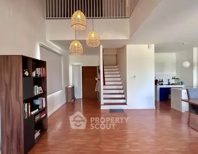 Spacious modern living room with high ceiling and elegant lighting