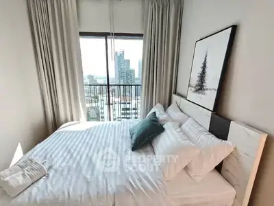 Modern bedroom with city view, featuring a cozy bed and elegant decor.