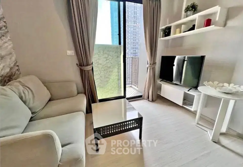 Cozy living room with modern decor and balcony access in urban apartment.