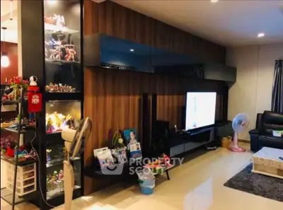 Modern living room with stylish wooden paneling and display shelves