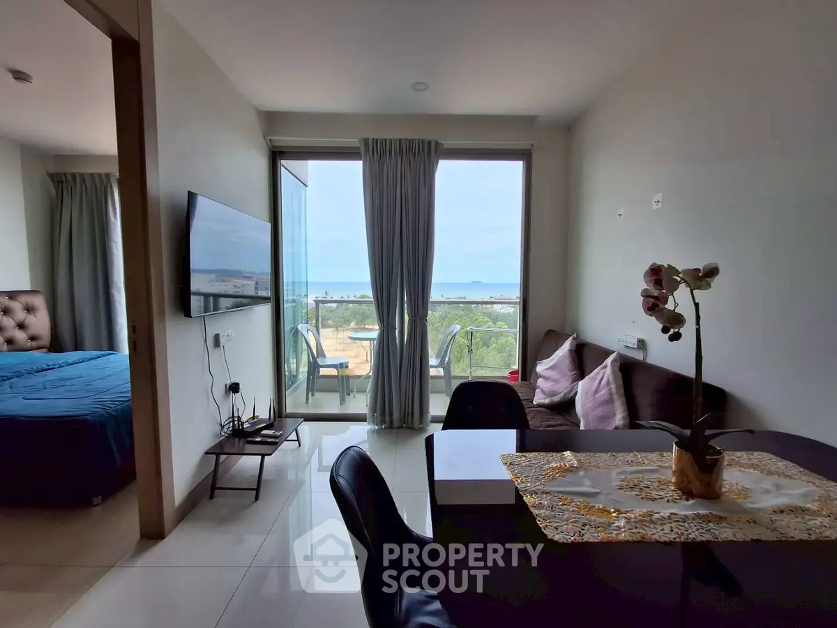 Modern apartment with ocean view, open living space and elegant decor.